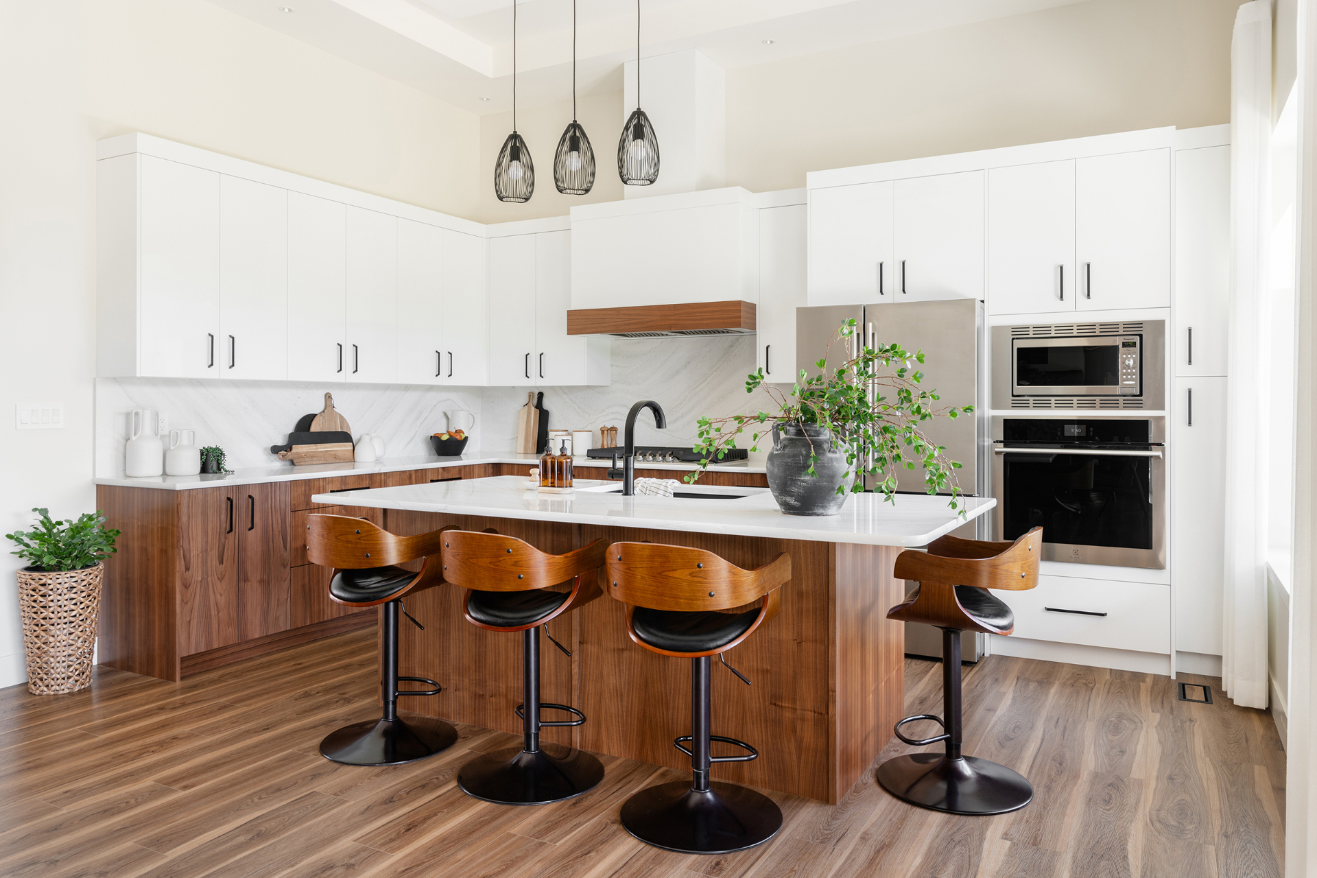 Two-tone kitchen with crisp white upper cabinets and warm walnut lower cabinets and island